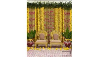 Photo of Seating arrangement with a floral backdrop.